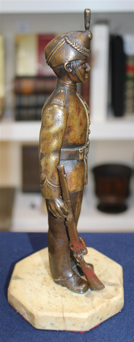 An early 20th century patinated military bronze model of a Kings Royal Rifle Corps soldier, 10.5in.